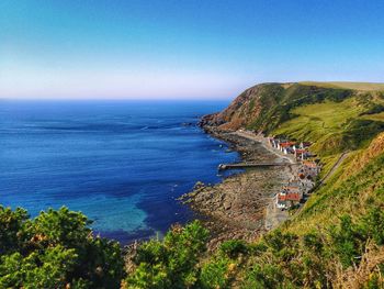 High angle view of people on beach against clear sky