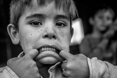 Close-up portrait of boy making face