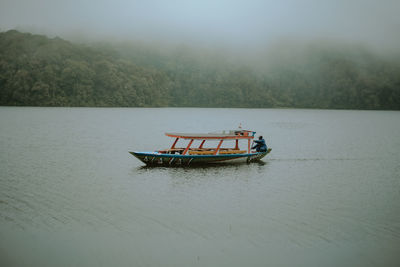 Boat in lake against sky