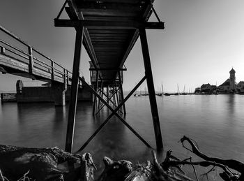 Low angle view of bridge over sea against clear sky