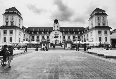 Group of people in front of buildings in city