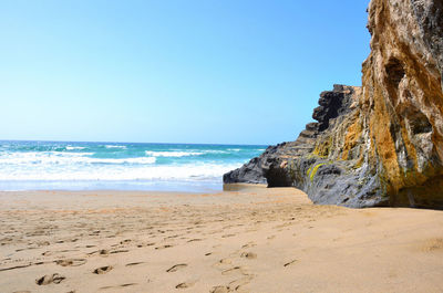 Scenic view of beach against clear sky