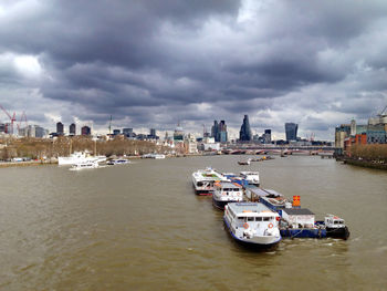 High angle view of boats in river against buildings