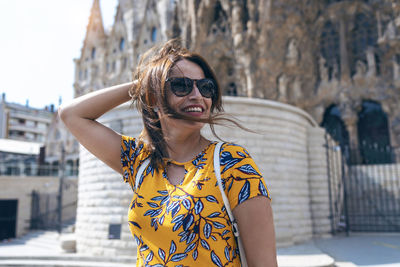 Portrait of smiling young woman in city