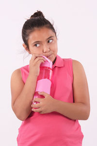 Portrait of a beautiful young woman drinking glass