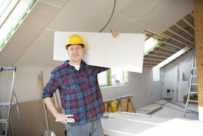 Portrait of young man working at construction site