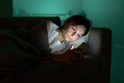 Addicted from social media woman surf internet in dark room at night. sleep disorder problem concept