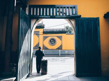 Man standing at entrance of building