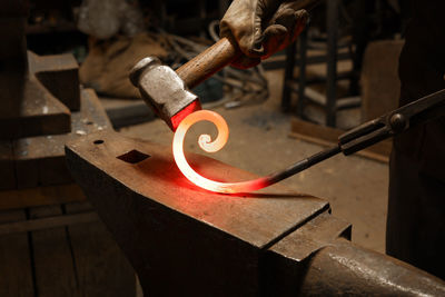 Close up view of heated metal and anvil. the blacksmith in the production process of metal products