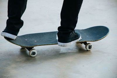 Low section of person standing on skateboard