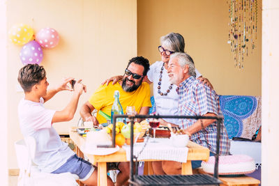 Cheerful family having food on table