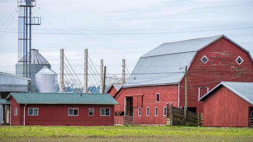 Barns and silos against sky