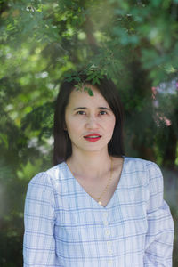 Portrait of a beautiful young woman standing outdoors