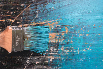High angle view of blue paint on table
