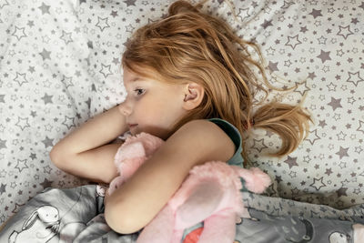 Cute girl lying on bed at home