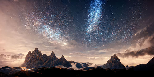 Scenic view of mountains against sky at night