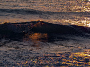 Aerial view of sea against sky during sunset