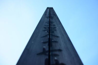 Low angle view of metal structure against blue sky