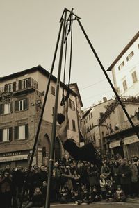 People on street in city against sky