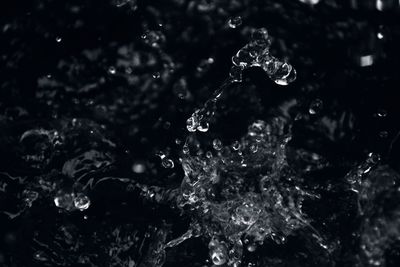 Full frame shot of water splash against black background