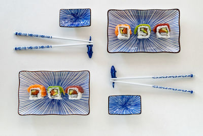 High angle view of various sushi on ceramic plates