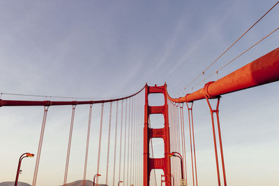 Low angle view of suspension bridge against sky
