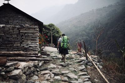 Rear view of man walking on mountain