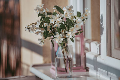 Close-up of flower vase on table at home