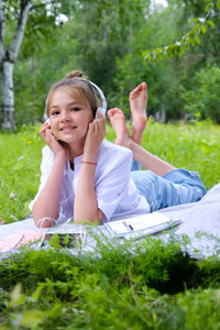 Portrait of young woman sitting on field