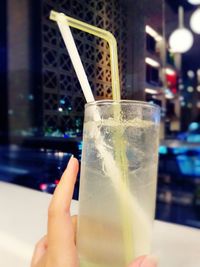 Close-up of hand holding glass of juice