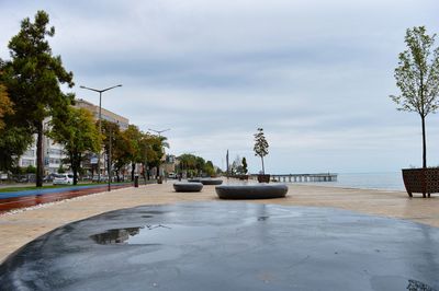 View of swimming pool by sea against sky