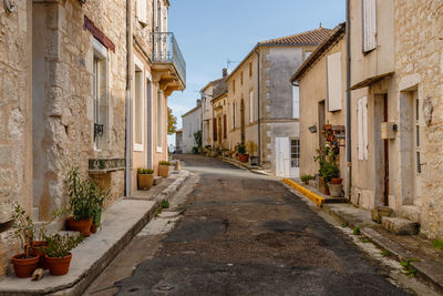 Empty street amidst buildings in city