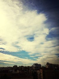 Buildings against cloudy sky