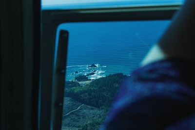 Close-up of sea against sky seen through window