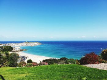 Scenic view of sea against clear blue sky