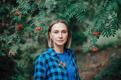 Closeup portrait of beautiful caucasian middle age woman in park looking in camera