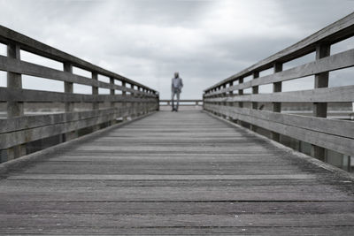 Pier over sea against sky