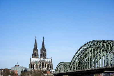 Hohenzollern bridge and cologne cathedral against blue sky