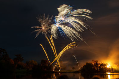 Low angle view of firework display at night