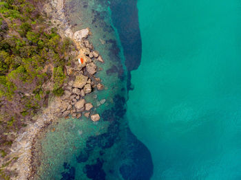 High angle view of rocks on sea shore