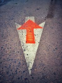 High angle view of arrow sign on road in city