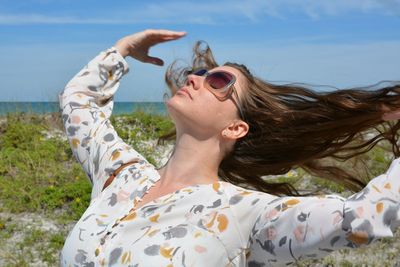 Portrait of woman with sunglasses against sky