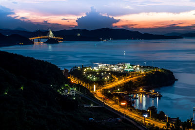 High angle view of illuminated city at waterfront