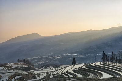 Scenic view of mountains against sky during sunset