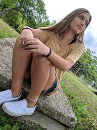 Young woman sitting in park