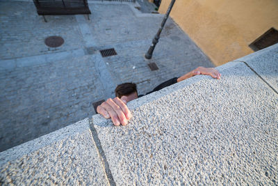 High angle view of man sitting on floor