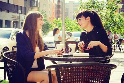 Smiling young woman sitting at restaurant