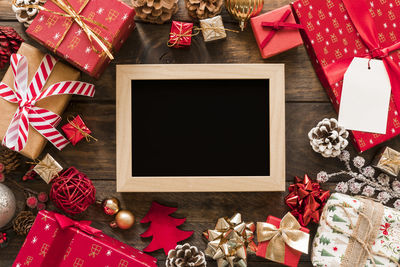 Cropped image of christmas and gifts on table