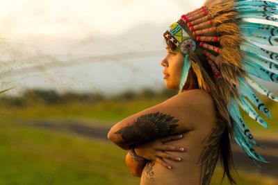 Side view of young woman standing outdoors