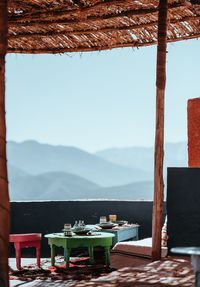 Chairs and tables at restaurant against sky